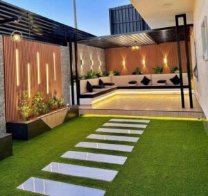 تصميم جلسات خارجية وممرات حجرية وتركيب عشب صناعي وتصميم أحواض زرع خارجية